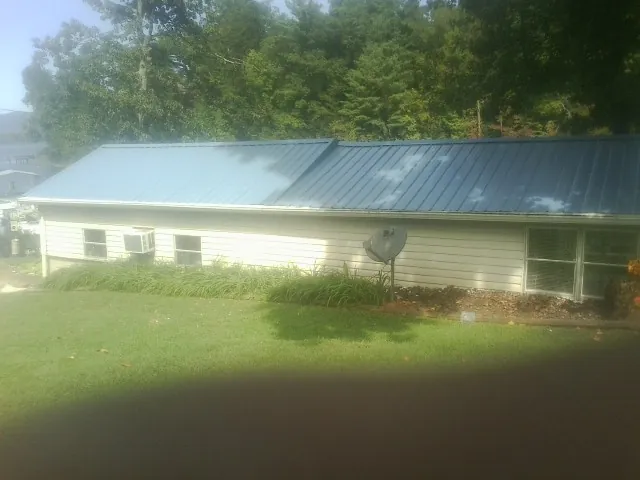 Blue metal roof running the length of a single story home in Urbandale